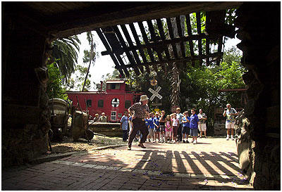 Dick Macy encourages the children to enter the tunnel under the drawbridge at Rubel Castle.