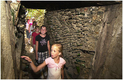 More bottles line the shoring walls of a tunnel leading from the castle to the old citrus buildings known as the Tin Palace.