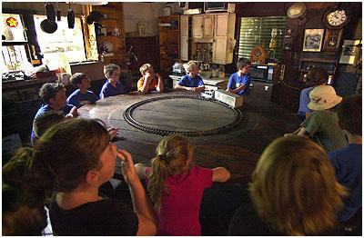 Students sit around the giant round table, once the scene of huge meals served during the construction of Rubel Castle.