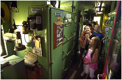 Cullen Elementary Students inside the caboose parked outside Rubel Castle. 